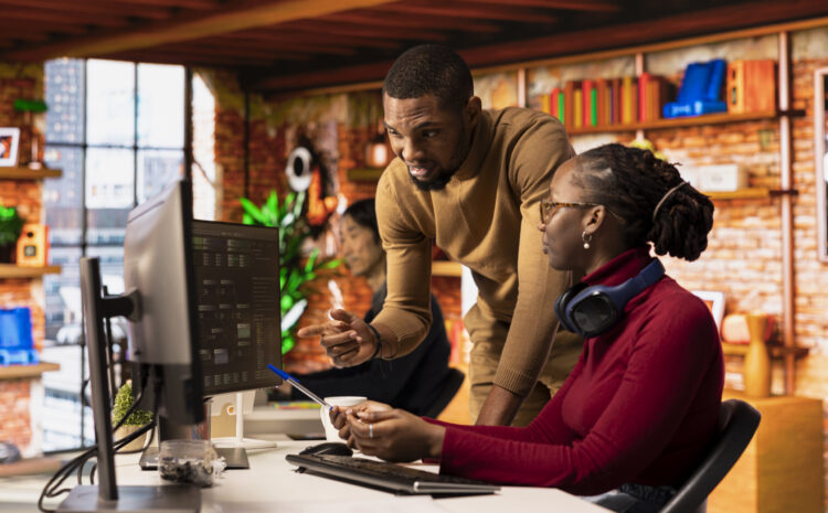 Teamworking startups employees leveraging machine learning technology in office to gain competitive edge. Silicon Valley company colleagues collaborating to do rapid technological advancement