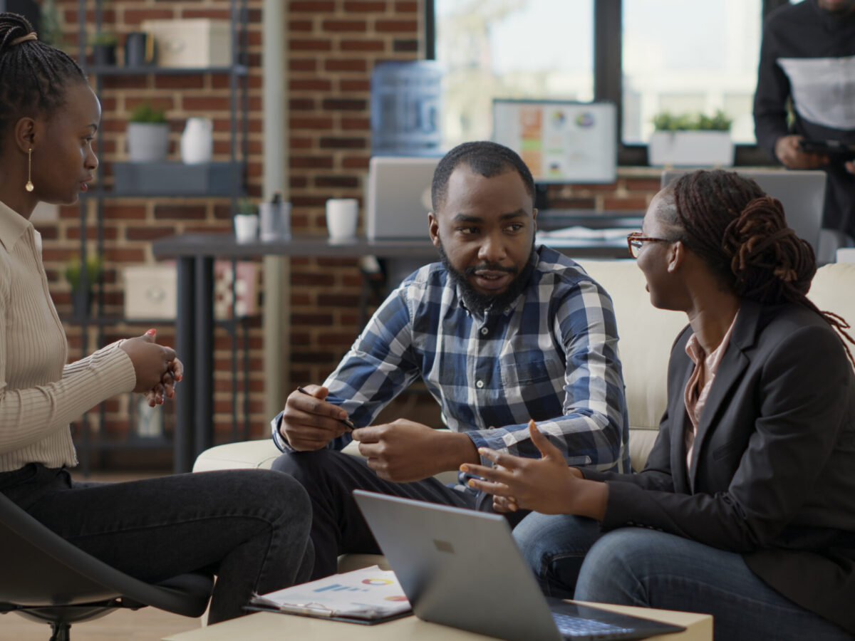 Team of business people collaborating to plan financial strategy, doing teamwork to create sales report on laptop. Office employees working on project strategy to analyze career growth.
