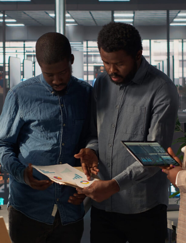 black-leader-reviews-company-strategy-with-her-team-members-corporate-office (1)