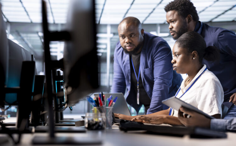 Team of data center office technicians using programming languages to construct algorithms and build applications. Server hub IT staff members debugging and optimizing code